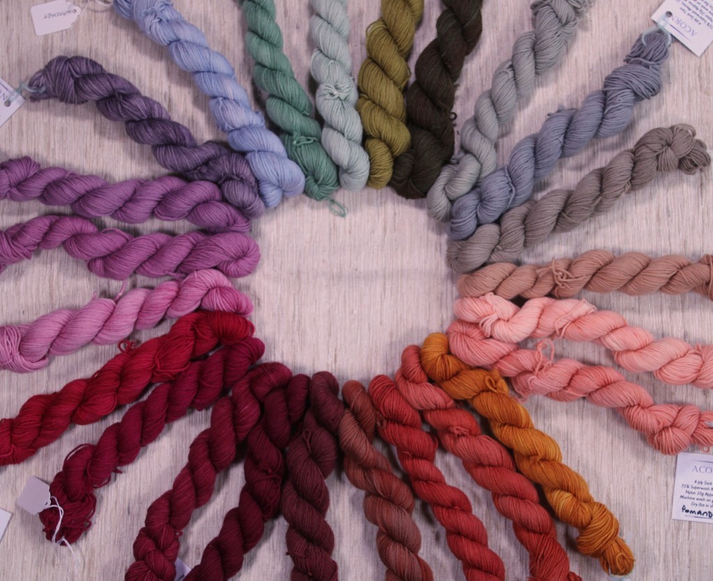 24 skeins of thread in various shades arranged in a circle