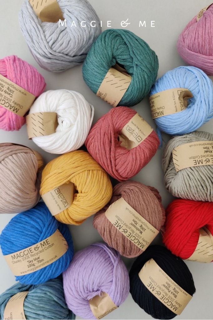 a top down photo of lors of balls of Maggie & Me yarn in various colours