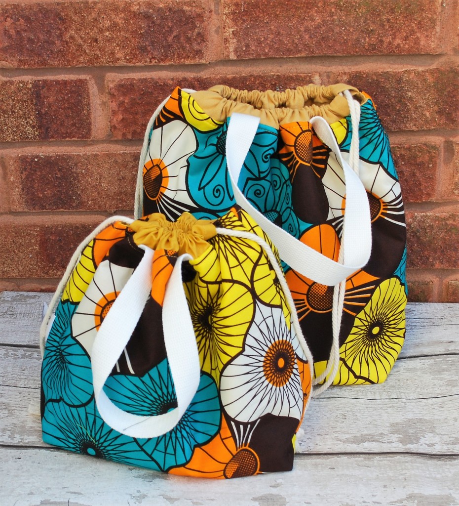 two handmade project bags in bright fabric in shades of blue, yellow and orange